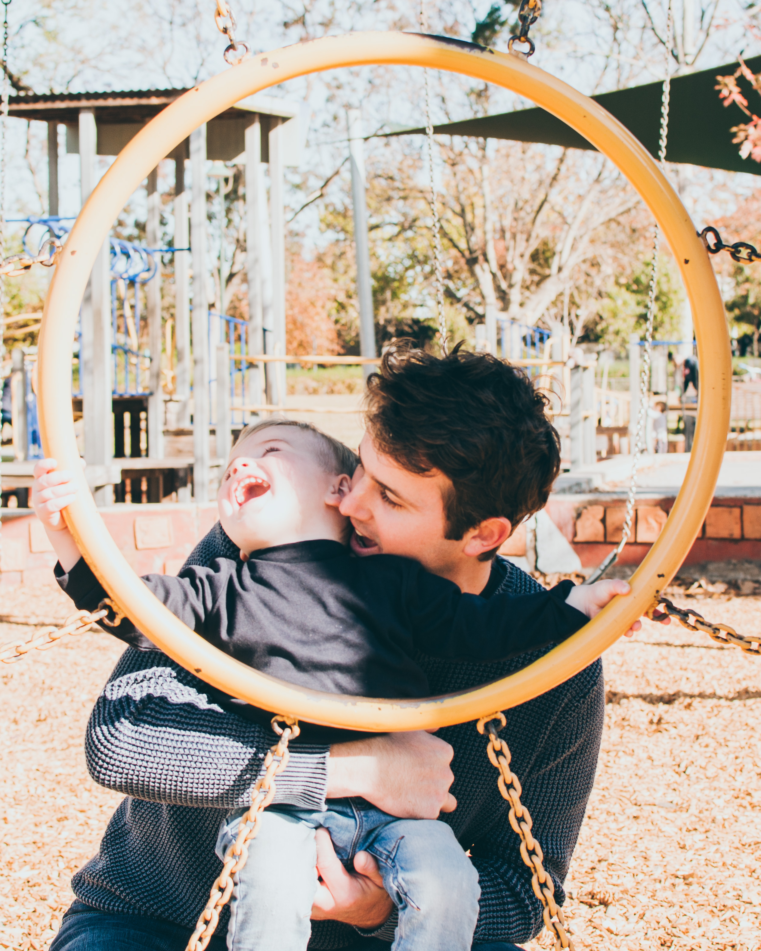 Melbourne Lifestyle Family Photography happy father and son hugging and playing at Curtain Square playground