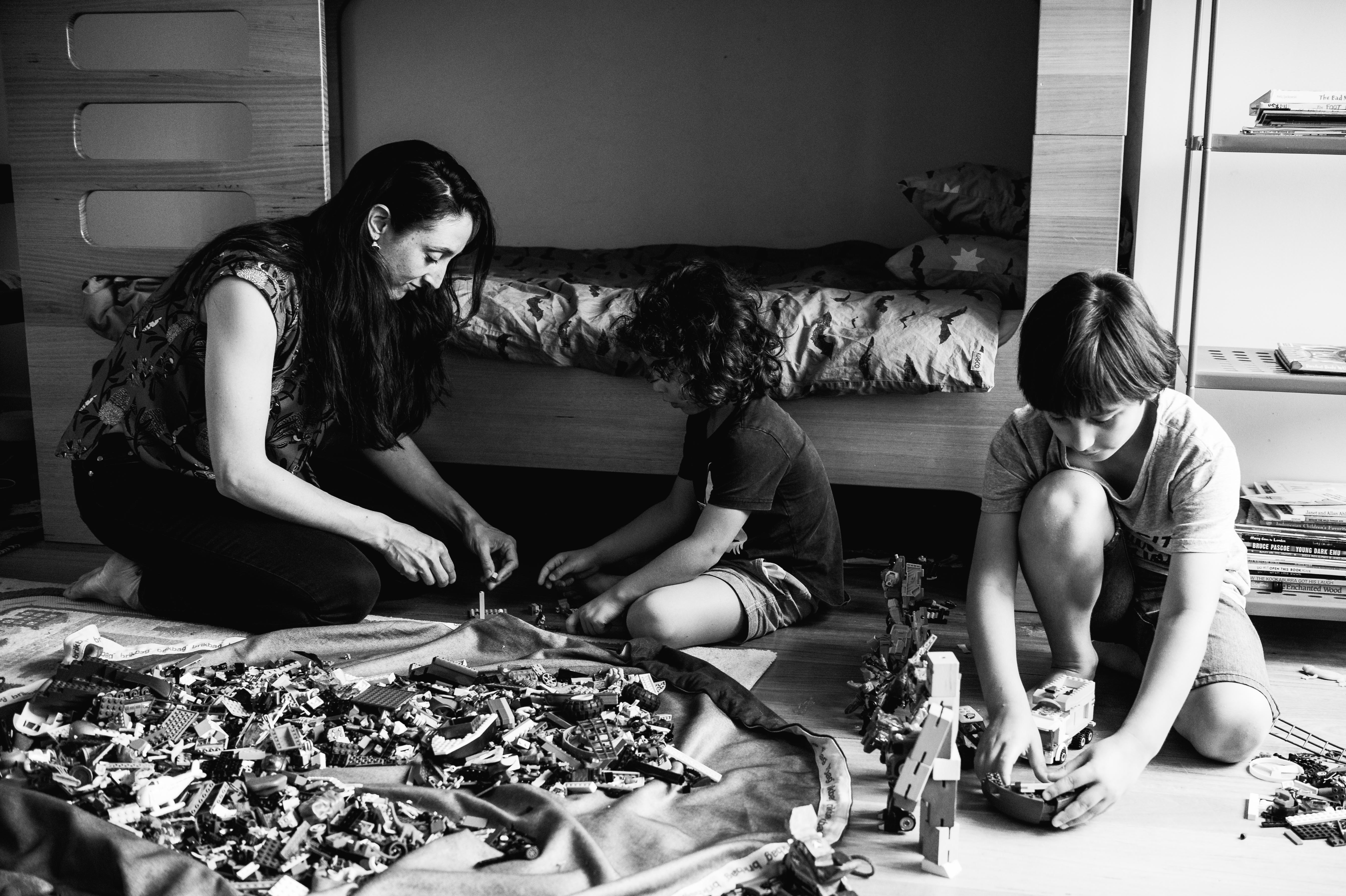 photograph of mother and her boys creating and building with Lego in their bedroom in Carlton North, Melbourne, Australia