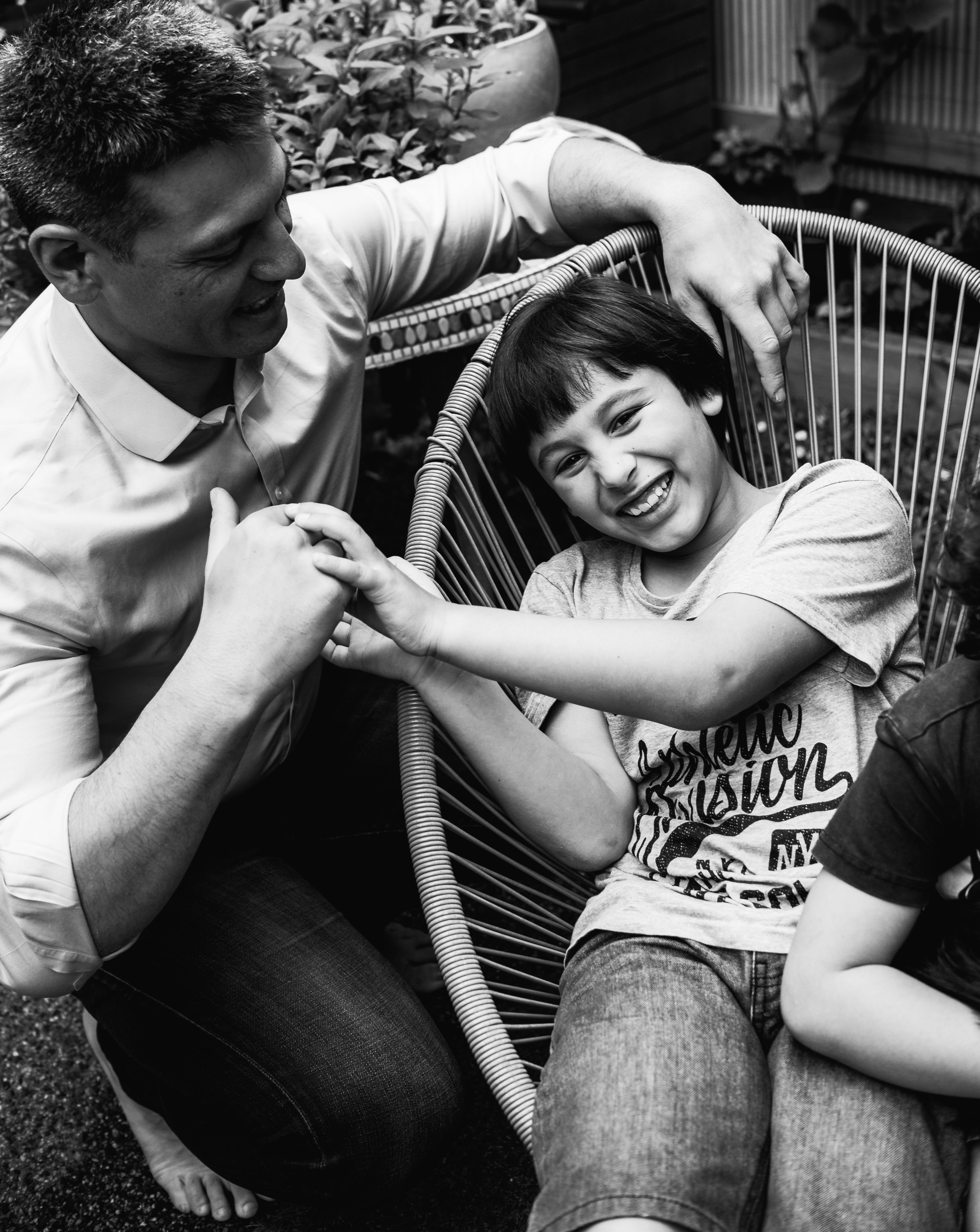 photograph of a boy getting tickled by his father in Carlton North, Melbourne, Australia