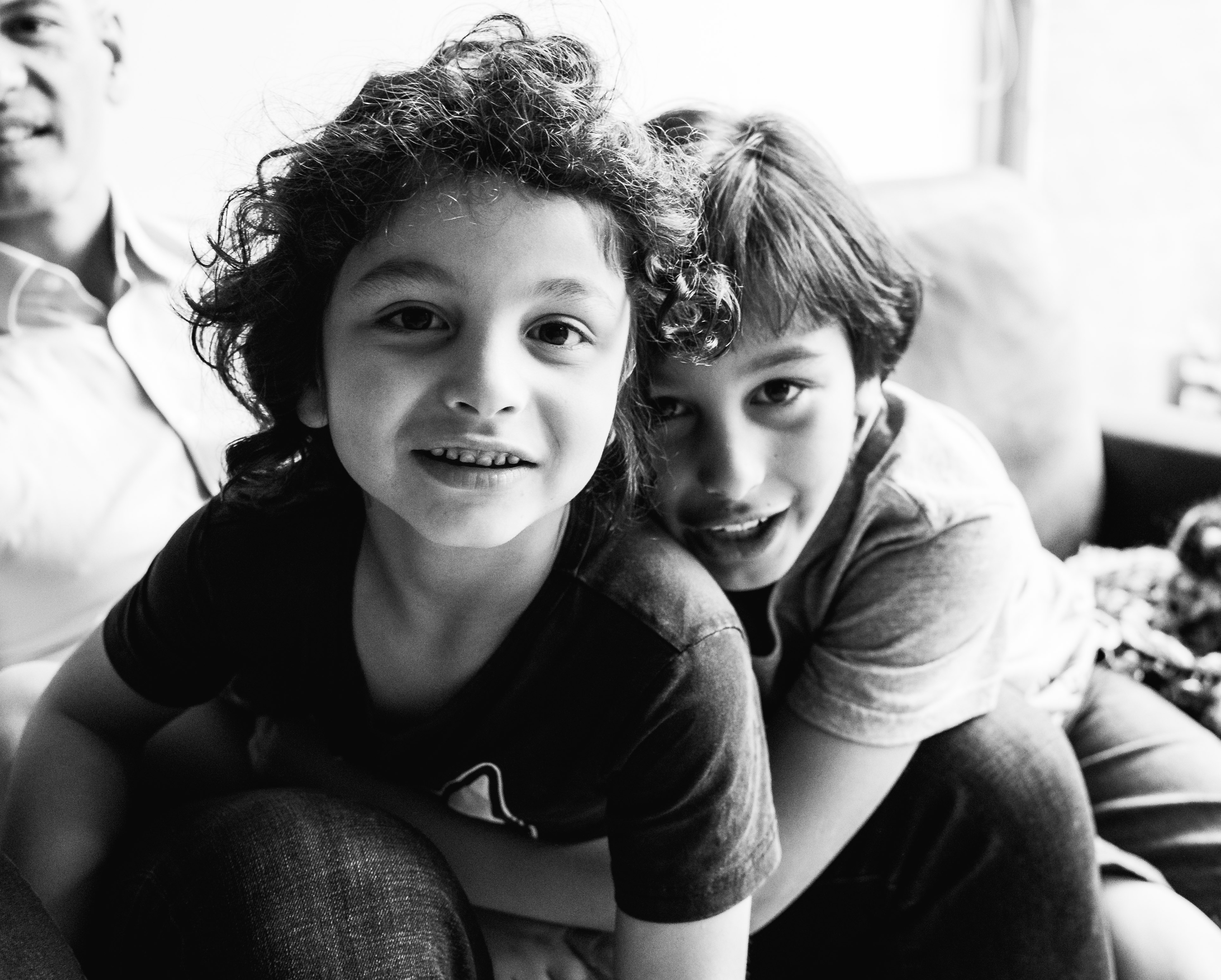 photograph of brothers cuddling and looking straight into camera lens in Carlton North, Melbourne, Australia