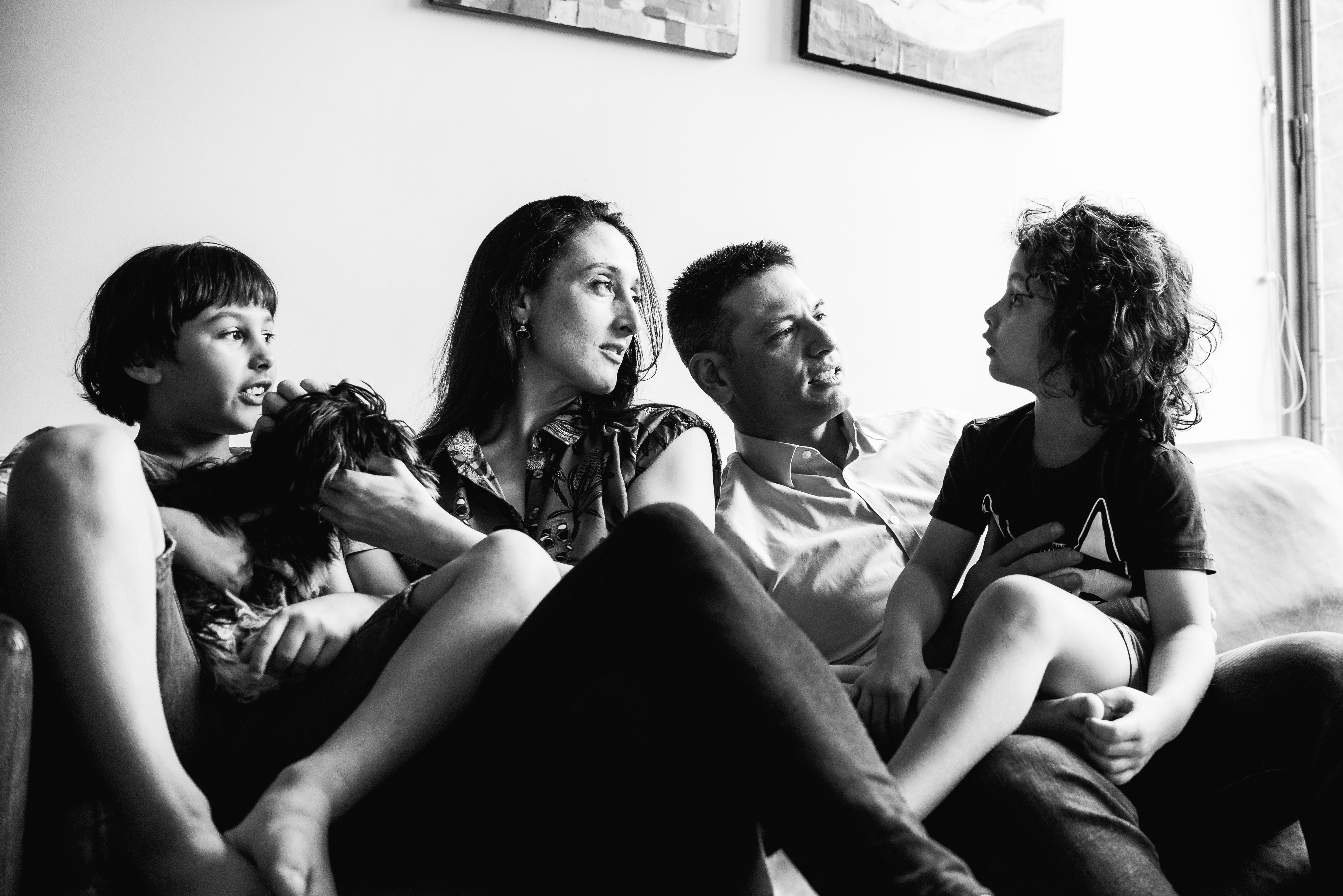 photograph of parents, children and pet as they listen to the youngest member of the family in Carlton North, Melbourne, Australia
