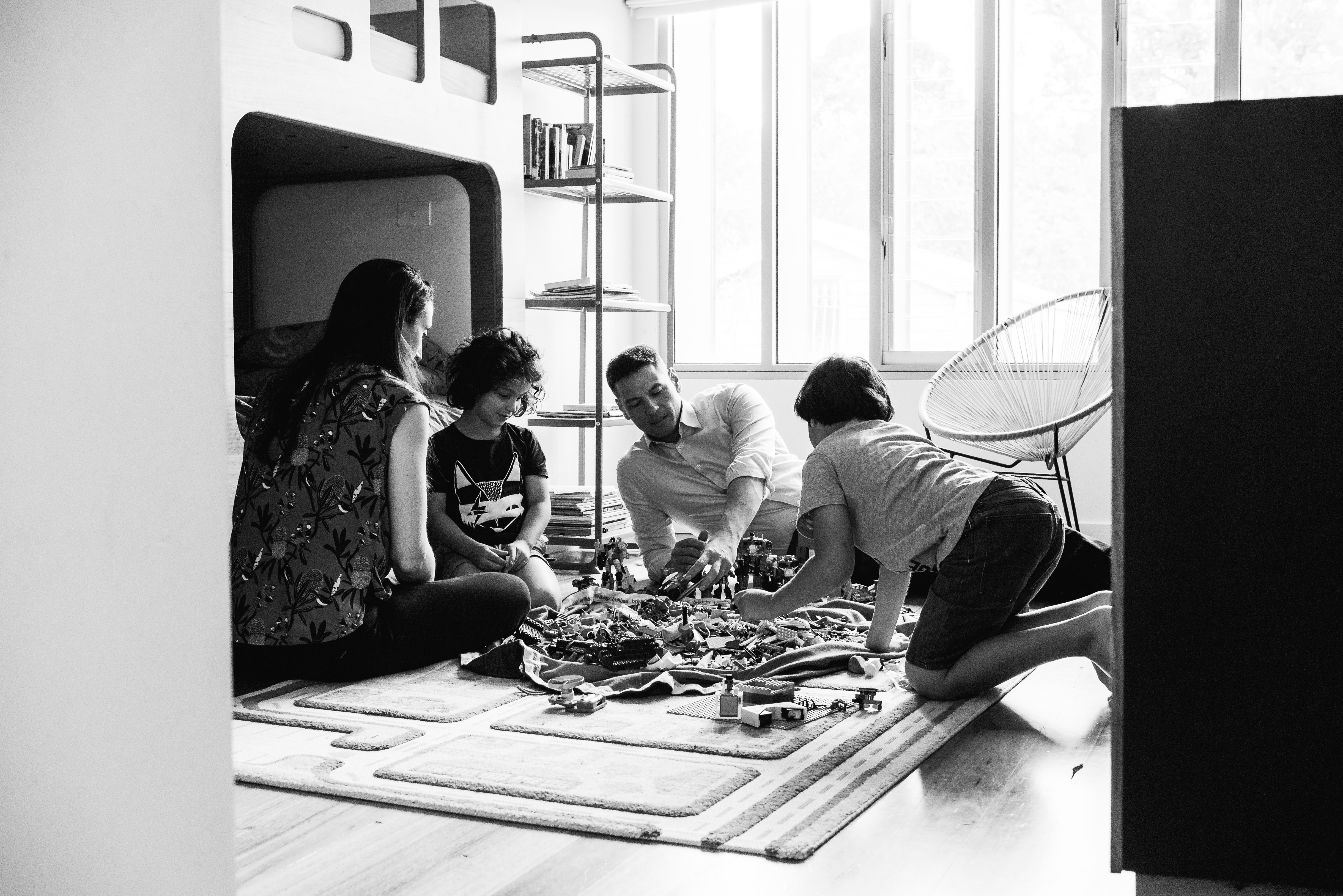 photograph of parents and their children creating and building with Lego in their bedroom in Carlton North, Melbourne, Australia