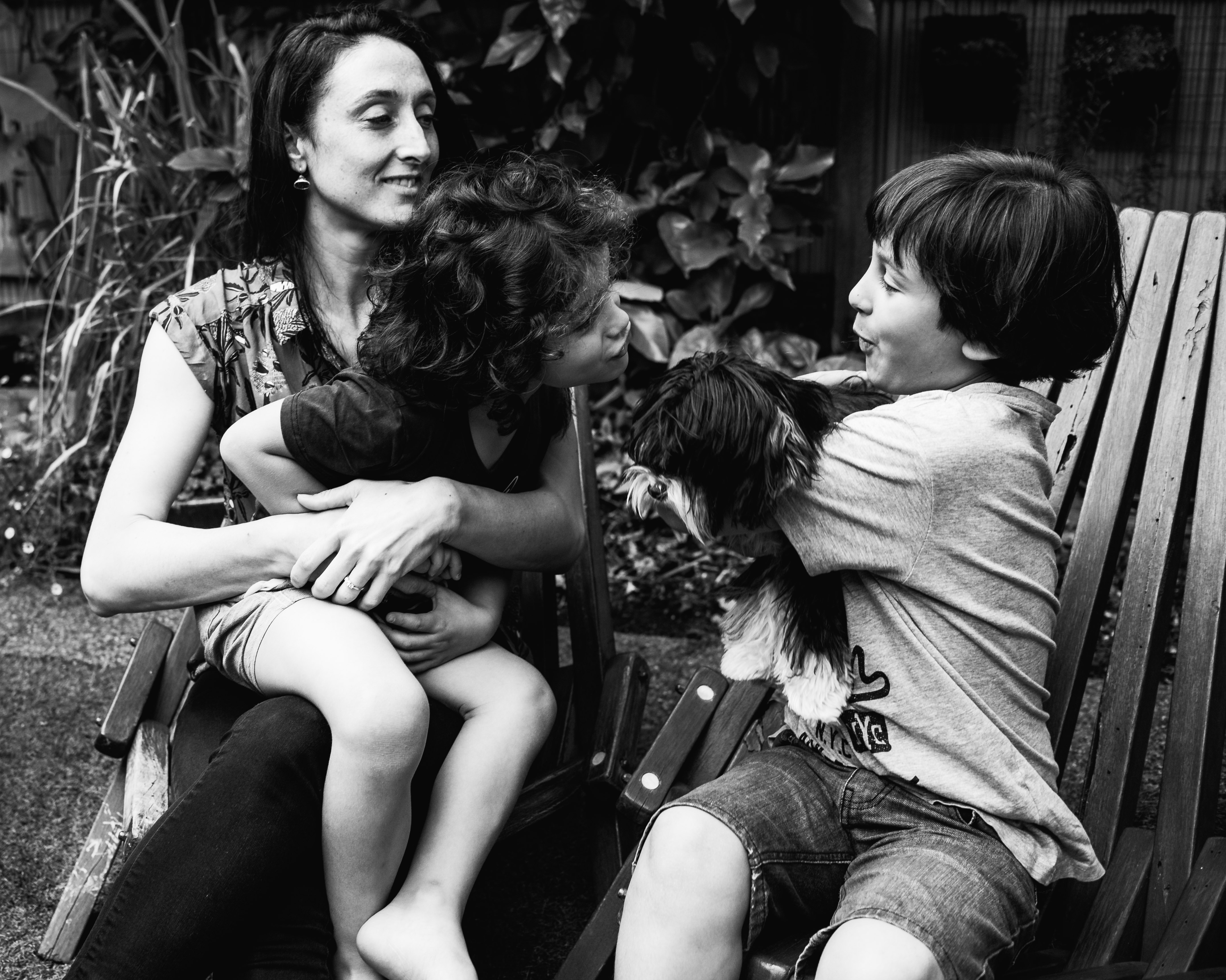funny photograph of a boy pretending to kiss his pet dog in Carlton North, Melbourne, Australia