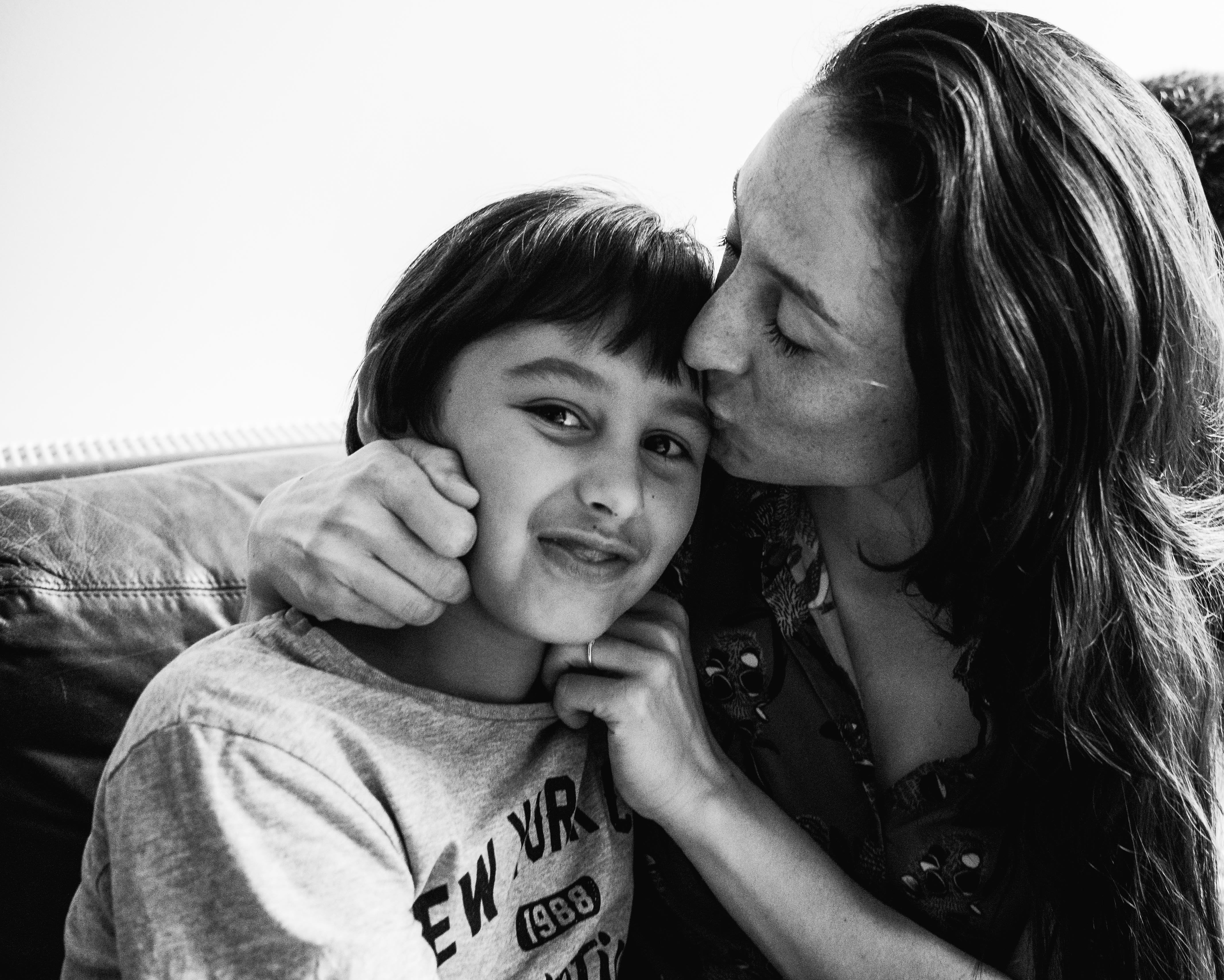 photograph of mother kissing and cuddling her son in Carlton North, Melbourne, Australia