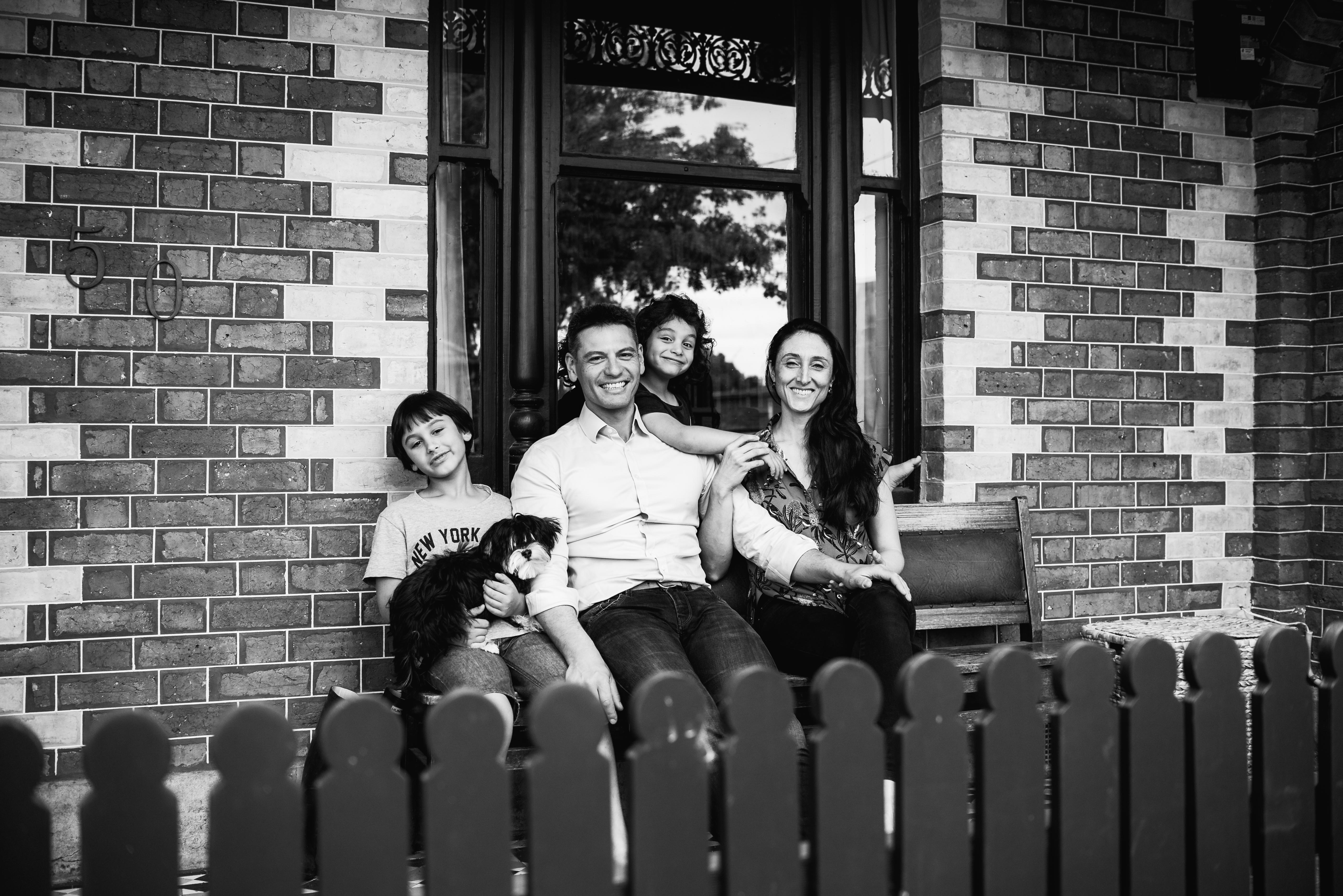 photograph of a family sitting at the front of their home in Carlton North, Melbourne, Australia