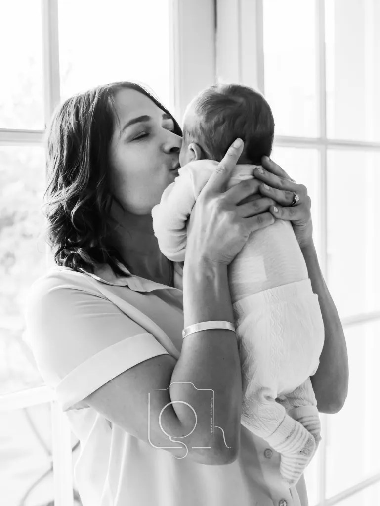 A lifestyle photography session with a Melbourne family in their home. An intimate moment with a mother and her newborn baby girl. Photograph by Liyat Haile.