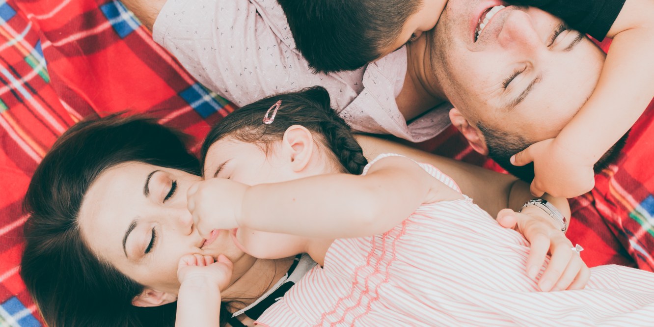 Melbourne Lifestyle photographer Liyat G Haile documents and captures happy family lying on picnic blanket, smiling, hugging, interacting and connecting